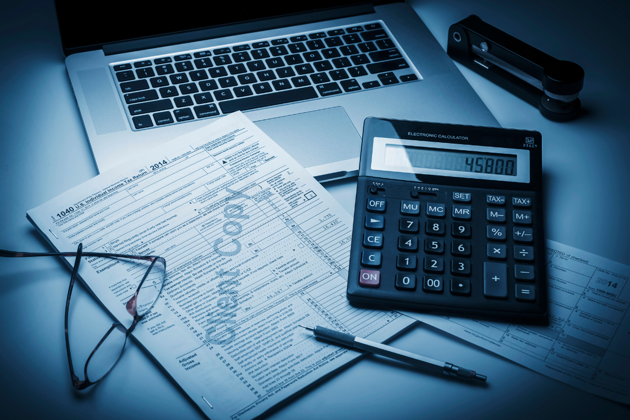 Mesa de trabajo con documentación laboral, teclado y calculadora